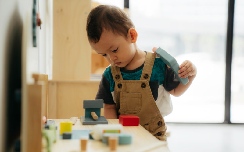Boy plays with building blocks